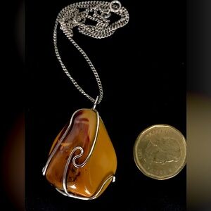 A sterling silver necklace with wire wrapped agate. 20” total length.